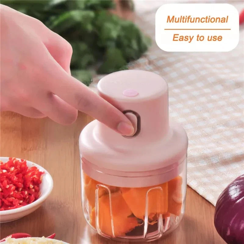 Handheld food chopper with vegetables on a table, labeled as multifunctional and easy to use.