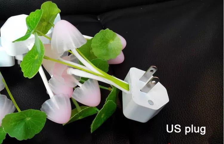 White US plug on a black background with green leaves and pink flowers.