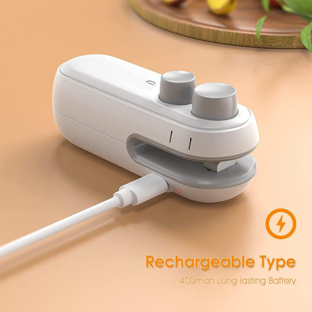 White and gray electronic device with charging cable on a beige surface