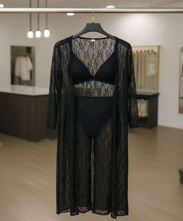 Black lace lingerie set with matching robe on a hanger in a store setting.