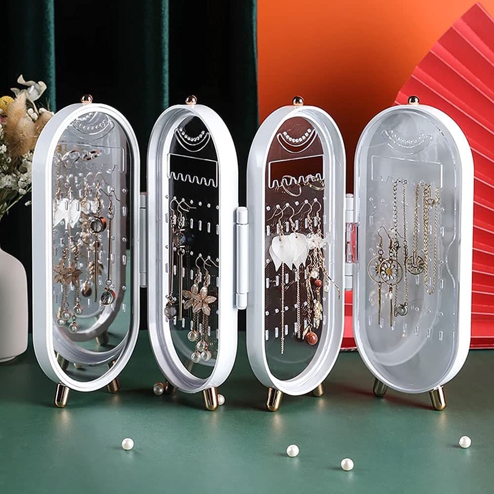 Four oval jewelry organizers with various earrings on a green surface.