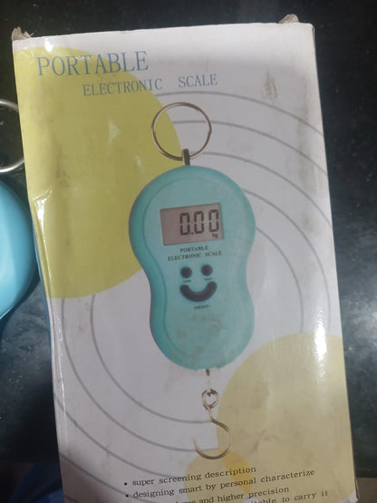 Portable electronic scale with a smiley face design on a dark background