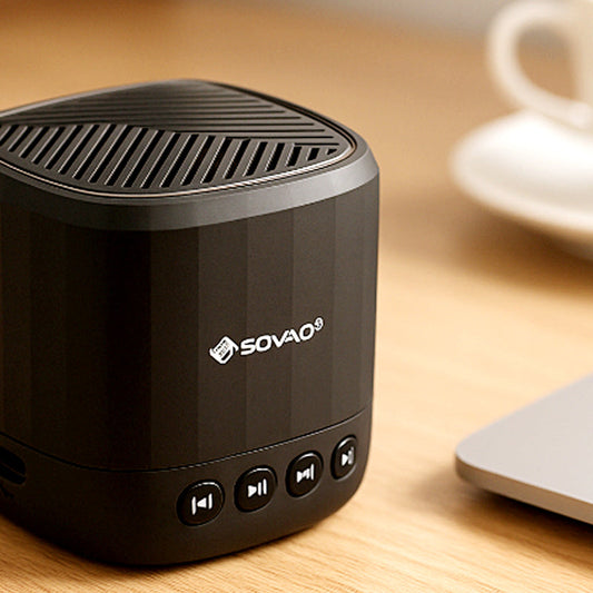 Black portable speaker with Sovao branding on a wooden surface