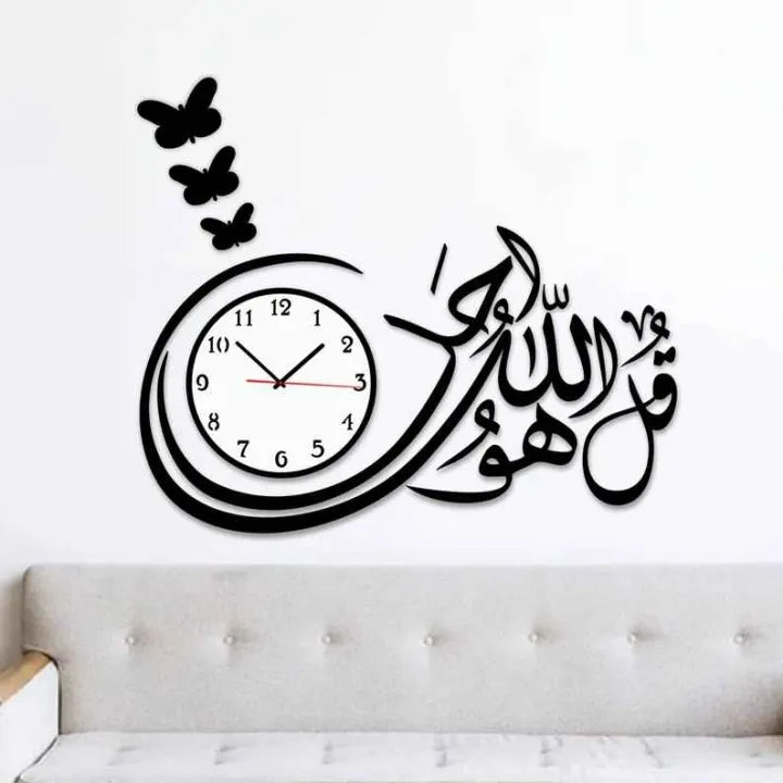 Wall clock with Arabic calligraphy and butterfly decals on a white wall.