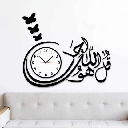 Wall clock with Arabic calligraphy and butterfly decals on a white wall.