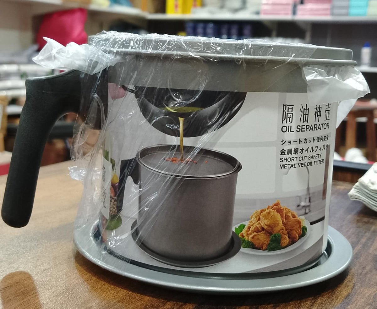 Oil separator with a clear plastic cover on a wooden surface
