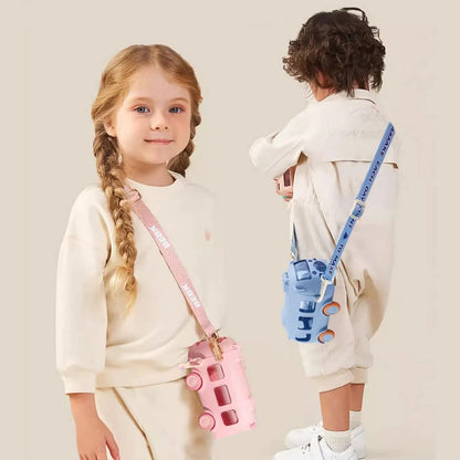 Two children with pink and blue toy cameras on a plain background