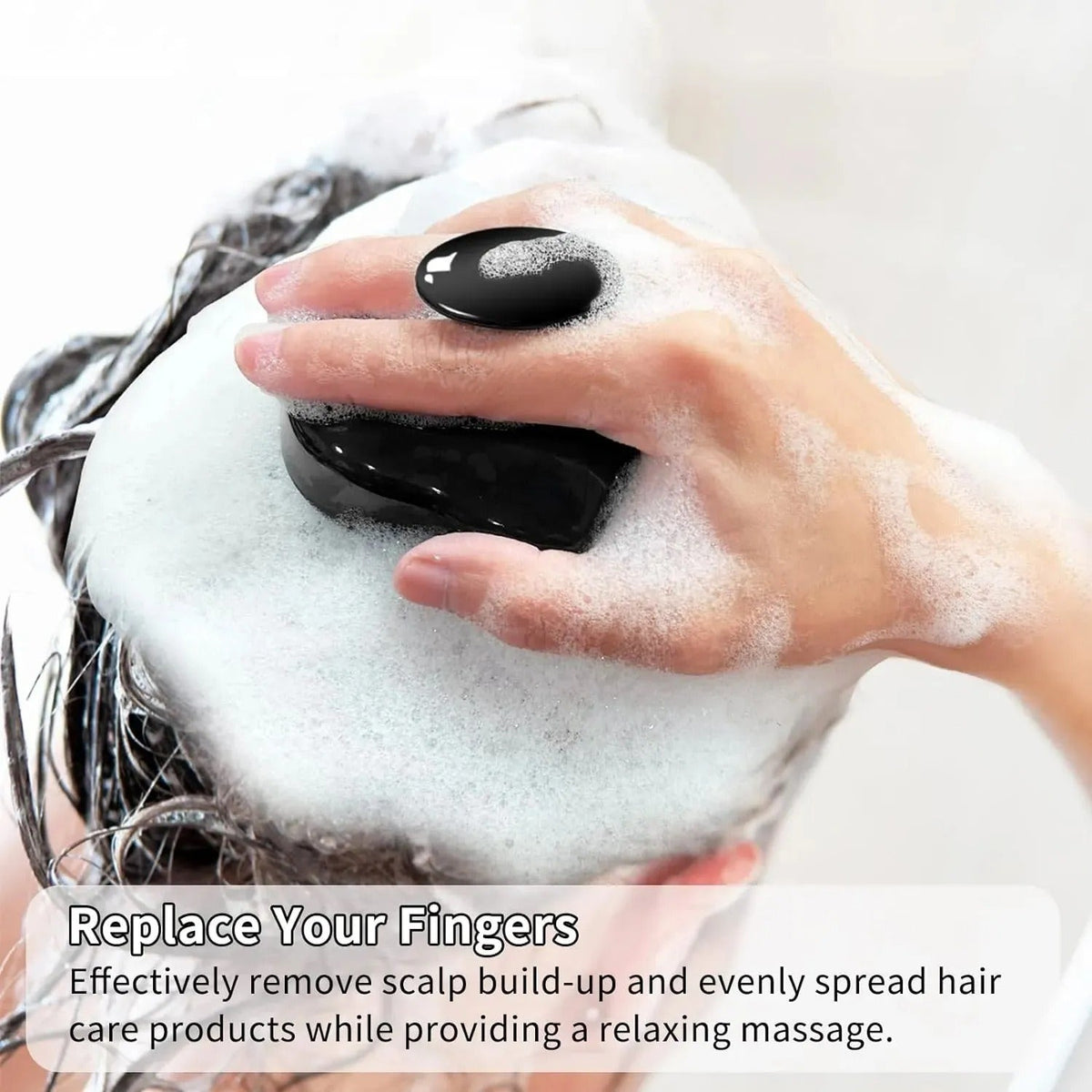 Person using a black handheld massager on soapy hair with text overlay.