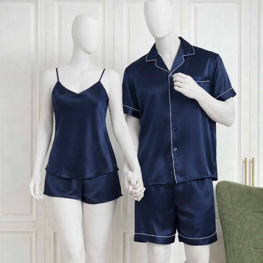 Navy satin pajama set on mannequins against a white wall.