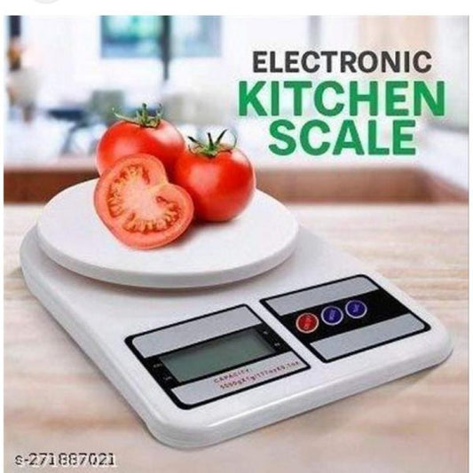 Electronic kitchen scale with tomatoes on a wooden surface